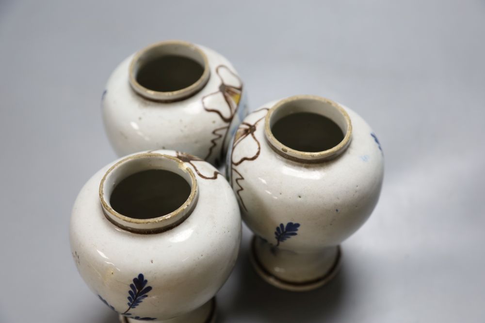 A set of three 19th century Dutch delft baluster jars, painted in colours, 14cm